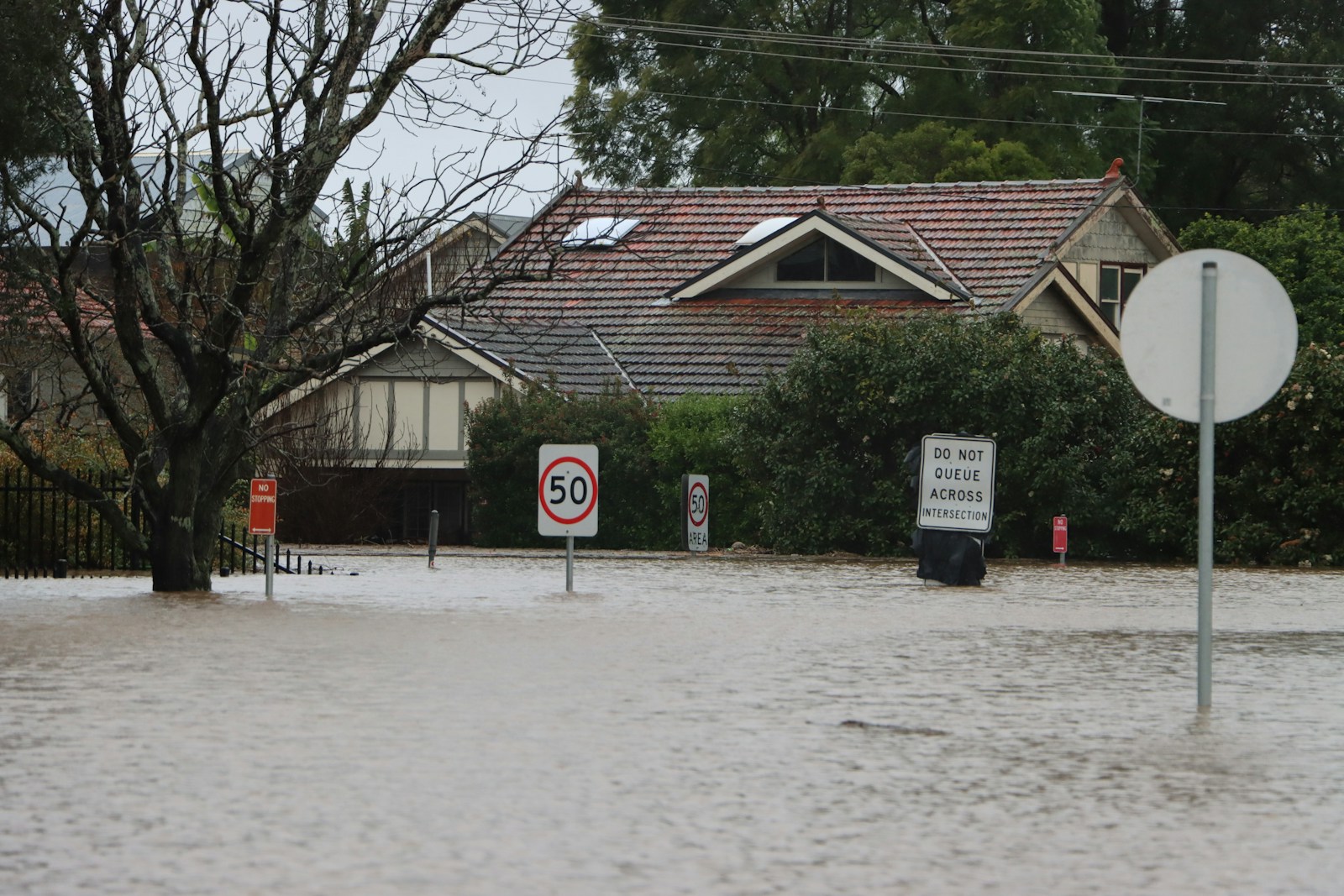 a house with a sign in front of it, flood